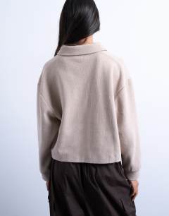 Model wearing Soft touch boxy long sleeve polo in taupe