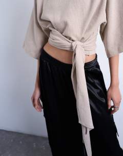 Model wearing Soft touch funnel neck tie waist detail top in taupe