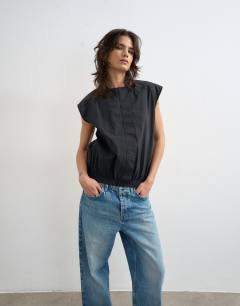 Model wearing Soft zip through structured shoulder top in black 