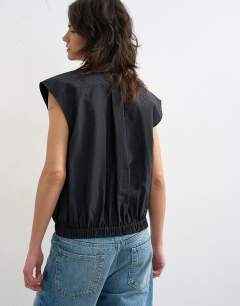 Model wearing Soft zip through structured shoulder top in black 