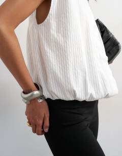 Model wearing Soft zip through structured shoulder top in white stripe