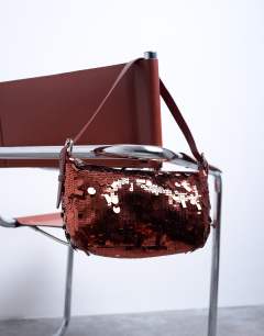 Model wearing Sol shoulder sequin bag with leather handle in rust