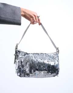 Model wearing Sol shoulder sequin bag with leather handle in silver