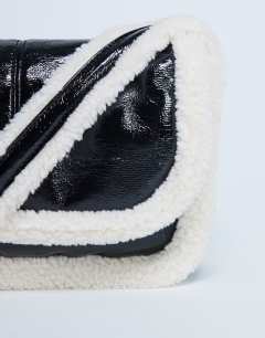 Model wearing Solo borg trim shoulder bag in black & white