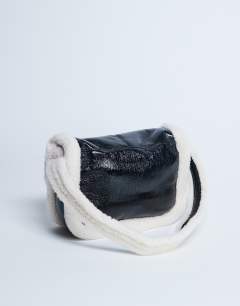 Model wearing Solo borg trim shoulder bag in black & white
