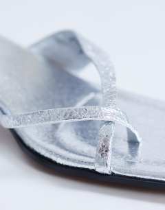 Model wearing Solo strappy mule mid heel sandal in silver