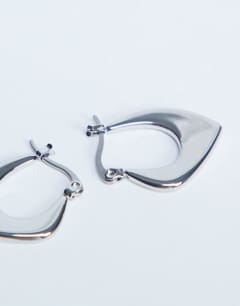 Model wearing Sonia waterproof stainless steel hoop earrings in silver