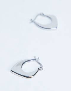 Model wearing Sonia waterproof stainless steel hoop earrings in silver