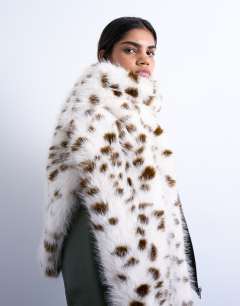 Model wearing Sophie faux fur scarf in dalmatian