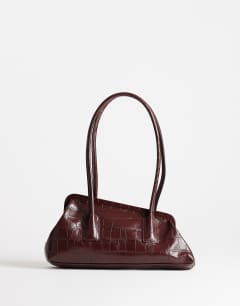 Model wearing Sophie medium angular shoulder bag in chocolate