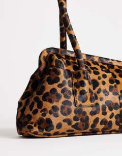 Model wearing Sophie medium hair on real leather angular shoulder bag in leopard print