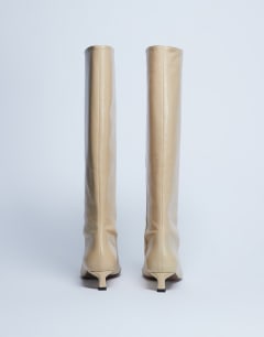 Model wearing Sophie Premium leather point toe knee high boot in buttermilk