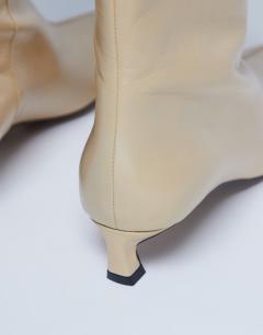 Model wearing Sophie Premium leather point toe knee high boot in buttermilk