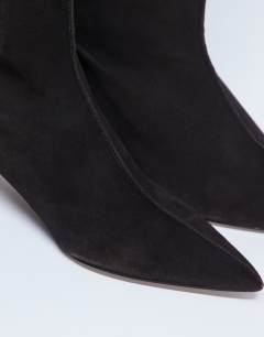 Model wearing Sophie Premium leather point toe knee high boot in chocolate