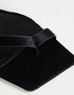 Model wearing Sophie strappy mid heel sandal in black print hair on real leather