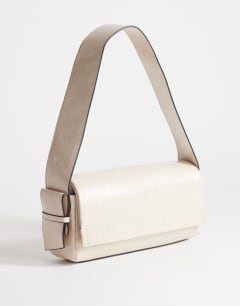 Model wearing Spencer medium strap detail shoulder bag in stone