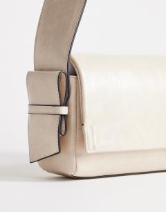 Model wearing Spencer medium strap detail shoulder bag in stone