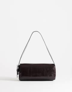 Model wearing Spencer strap detail shoulder bag in chocolate