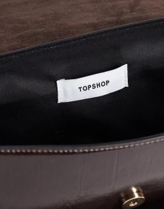 Model wearing Spencer strap detail shoulder bag in chocolate