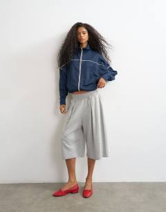 Model wearing Sports high neck piped jacket in navy