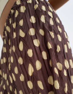 Model wearing Spot plisse wide leg trouser in brown