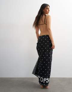 Model wearing Square sarong in black and white polka dot