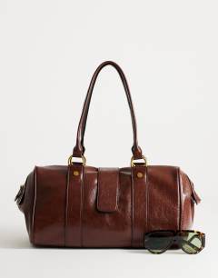 Model wearing Star hardware detail bowler shoulder bag chocolate