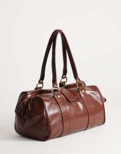 Model wearing Star hardware detail bowler shoulder bag chocolate