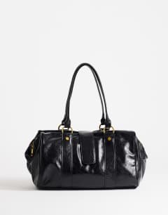 Model wearing Star hardware detail bowler shoulder bag in black