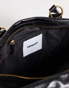 Model wearing Star hardware detail bowler shoulder bag in black