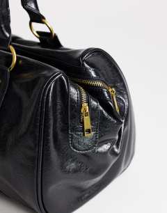 Model wearing Star hardware detail bowler shoulder bag in black
