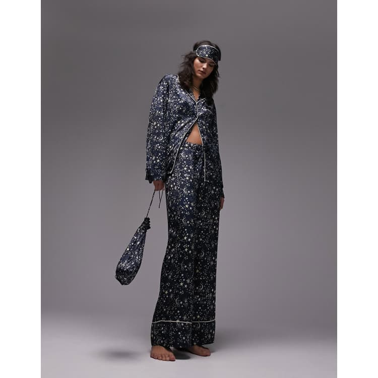 Topshop navy and white celestial print pyjama set with a matching drawstring bag and a sleep mask. Loose fit with white piping edging and button up shirt. 