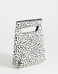 Model wearing Stella hair on real leather small grab bag in dalmatian print