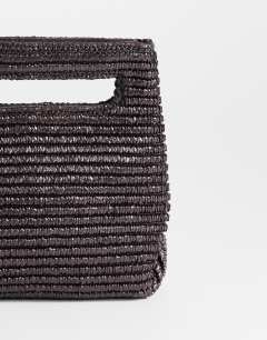 Model wearing Stella straw small grab bag in chocolate