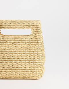 Model wearing Stella straw small grab bag in natural