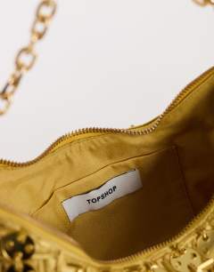 Model wearing Stellan sequin medium scoop shoulder bag in gold