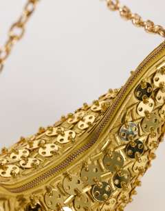 Model wearing Stellan sequin medium scoop shoulder bag in gold