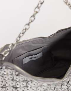 Model wearing Stellan sequin medium scoop shoulder bag in silver