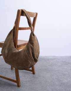 Model wearing Sterling real suede scoop shoulder bag in beige