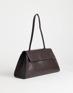 Model wearing Stevey shoulder bag in chocolate