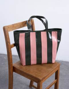 Model wearing Stevie large striped faux leather tote bag in pink & khaki