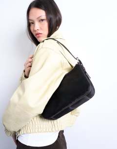 Model wearing Stina real leather shoulder bag in chocolate pony