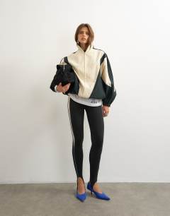 Model wearing Stirrup piping leggings in black