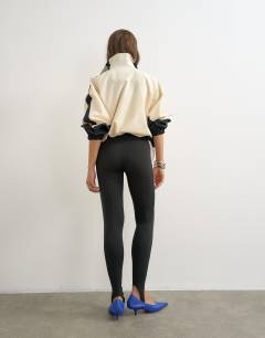 Model wearing Stirrup piping leggings in black