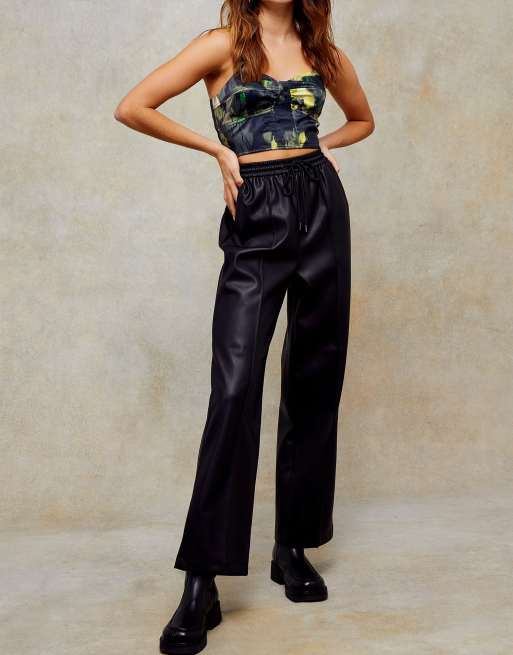 Topshop Petite faux leather flared trousers in black, ASOS