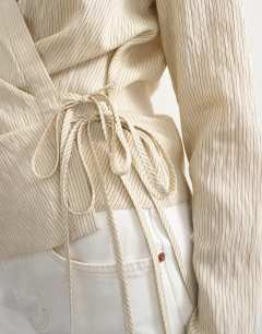 Model wearing Stripe asymmetric wrap tie shirt in beige