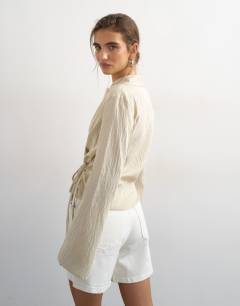 Model wearing Stripe asymmetric wrap tie shirt in beige