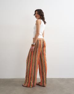 Model wearing Stripe crinkle tie waist wide leg trousers in orange