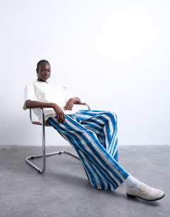 Model wearing Stripe crinkle wide leg trousers in navy