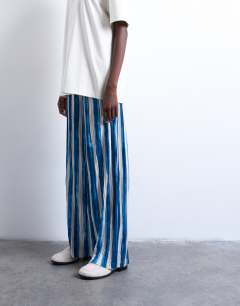 Model wearing Stripe crinkle wide leg trousers in navy
